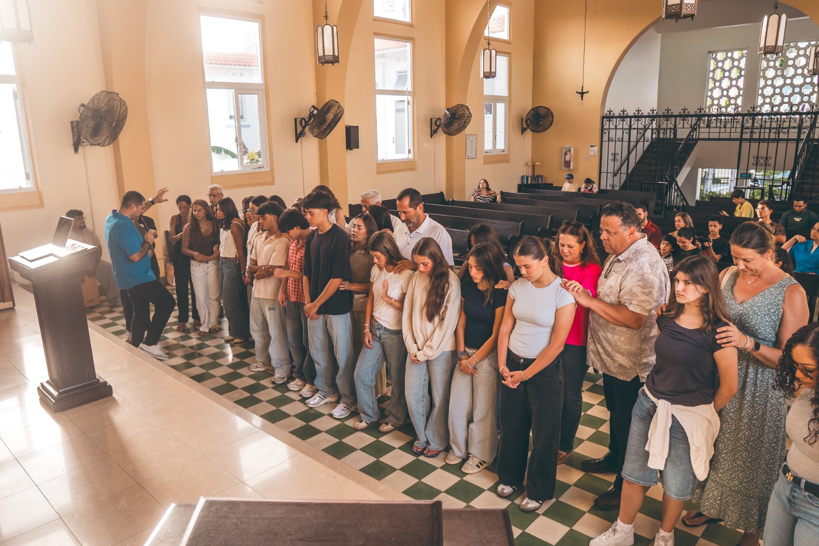Parents praying over students in the Robinson School chapel